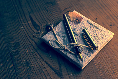 Old diary memories with fountain pen on a wooden table. Vintage processing.