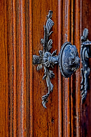 Detail of a medieval wooden door with ornaments. Double door open.