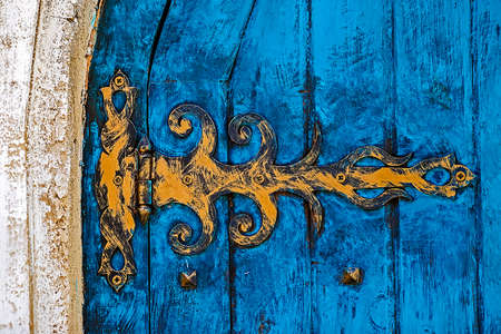 Stone wall texture background with ancient blue door.の写真素材