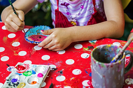 Children painting pottery at a workshop organized by the International Children's Day in Timisoara Romania.の写真素材