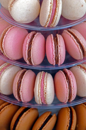 Sweet and colourful french macaroons placed in a plastic tower.