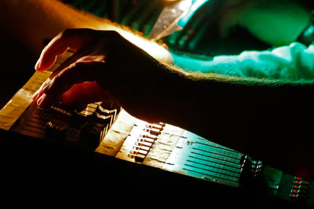 DJ hands on equipment and adjusting audio mixing console.