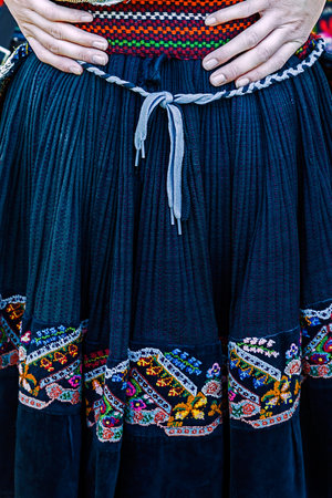 Detail of Serbian folk women skirt with multicolored embroidery.