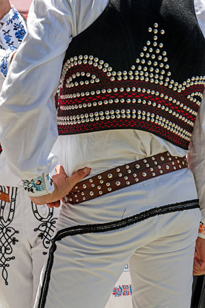 Detail of Czech folk costume for man with multicolored embroidery.