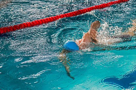 Athletic swimmer in action in a swimming poolの写真素材
