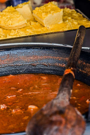 Bean soup prepared in a large bowl and traditional Romanian polenta in the background.の写真素材