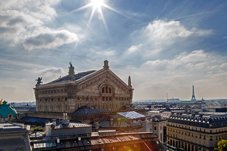 Paris, France - October 10, 2015: Aerial view with rooftop from terrace of Printemps store . Opera Garnier building in front and Eiffel tower on background. Sun reflection.のeditorial素材