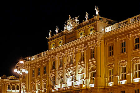Night view with architectural detail of facade at Lloyd Triestino palace in Unity of Italy Square.Trieste, Italy.の写真素材