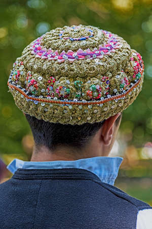 Hats traditional Bulgarian male, embroidered with popular models and placed on a man's head.の写真素材