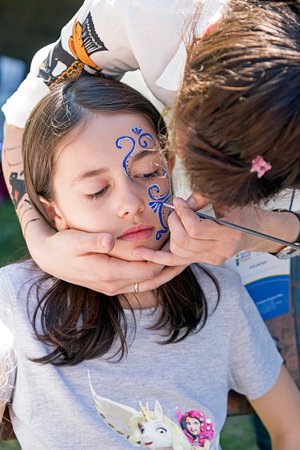 TIMISOARA, ROMANIA - MAI 07, 2016: Workshop for children face painting on a park in Timisoara,...