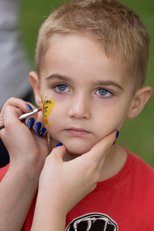 TIMISOARA, ROMANIA - JUNE 01, 2016: Workshop with face painting for children,  in a park in...