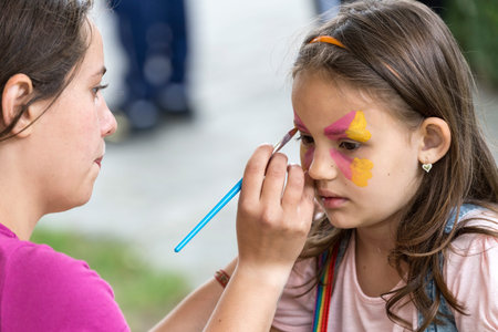 TIMISOARA, ROMANIA - JUNE 01, 2016: Workshop with face painting for children,  in a park in...