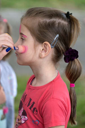 TIMISOARA, ROMANIA - JUNE 01, 2016: Workshop with face painting for children,  in a park in Timisoara, Romania. International children Day.のeditorial素材