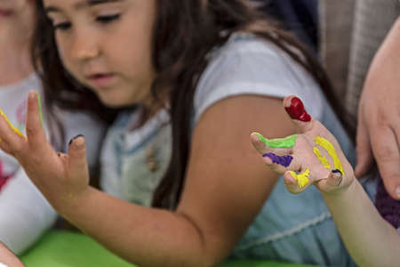 TIMISOARA, ROMANIA - JUNE 01, 2016: Kids painted hands.  Workshop organized by the City Hall Timisoara with the occasion of the International children Day. Happy childhood.のeditorial素材