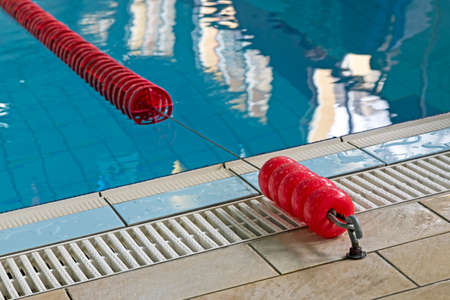 Background with a swimming pool and red markers between lanes competition.の写真素材