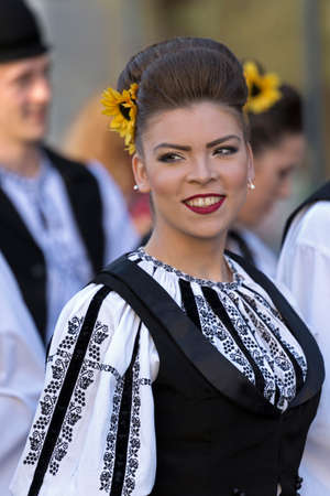 ROMANIA, TIMISOARA - JULY 7, 2016: Young woman from Romania in traditional costume, present at the international folk festival, "International Festival of hearts" organized by the City Hall Timisoara.のeditorial素材