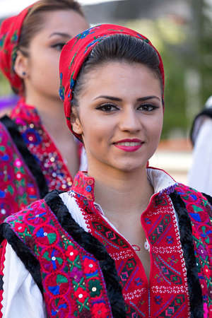 ROMANIA, TIMISOARA - JULY 7, 2016: Young woman from Romania in traditional costume, present at the international folk festival, "International Festival of hearts" organized by the City Hall Timisoara.のeditorial素材