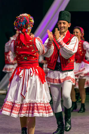 ROMANIA, TIMISOARA - JULY 7, 2016: Young Romanian dancers in traditional costume, perform folk dance during "International Festival of hearts" , organized by the City Hall Timisoara.のeditorial素材