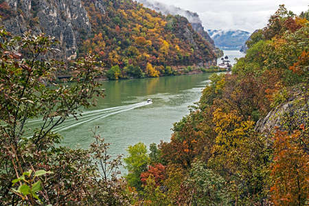 Autumn at the Danube Gorges, the border between Romania and Serbia. View from Serbian part. In the background, on the Romanian bank, monastery Mraconia.の写真素材