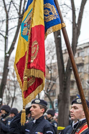 TIMISOARA, ROMANIA - DECEMBER 1, 2016: Military parade at Romanian National Day. Soldiers in formation with flag. Picture is taken in front of the Administrative Palace in Timisoara.のeditorial素材