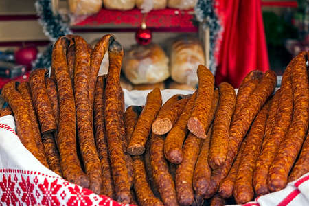 Romanian traditional sausages (carnati), placed in a wicker basket on a white cotton cloth.の写真素材