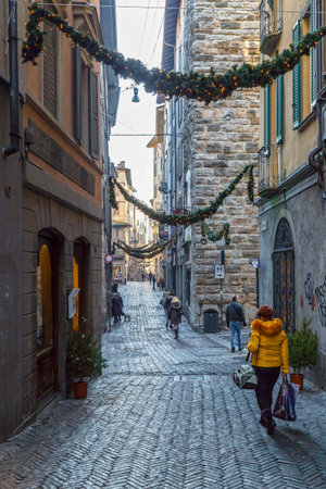 BERGAMO, ITALY - 12 DECEMBER 2016: Old and small street of medieval town (Citta Alta) with Christmas decoration.のeditorial素材