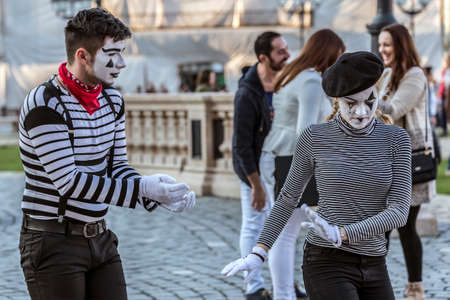 TIMISOARA, ROMANIA - MARCH 31, 2017: Pantomime couple with painted face, present on the street inside the CheckART Carnival organized by the City Hall Timisoara. Union Square.のeditorial素材