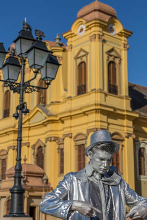 TIMISOARA, ROMANIA - APRIL 1, 2017: Living statue of a man, silver dressed and present on the street inside the CheckART Carnival organized by the City Hall Timisoara. Union Square.のeditorial素材