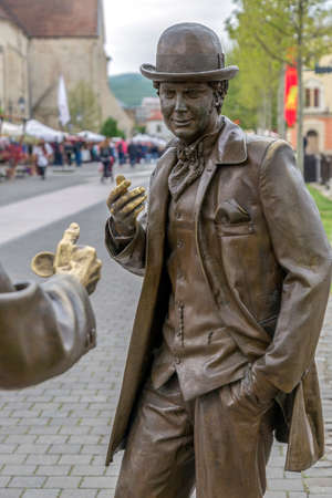 ALBA IULIA, ROMANIA - APRIL 29, 2017: Bronze statues depicting two town folks with toppers that having a conversation on the street in Alba Carolina Citadel square.のeditorial素材