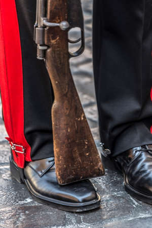 Detail of a protocol uniform of an Italian soldier. Black, red and rifle.の写真素材