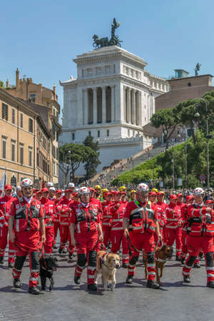 ROME, ITALY - JUNE 2, 2017: Italian Red Cross troops with dogs trained for rescue missions participating at the parade of national day of Italy. The Monument a Vittorio Emanuele II in background.のeditorial素材