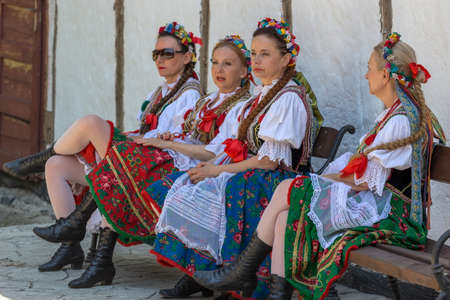 ROMANIA, TIMISOARA - JULY 9, 2017: Mature women dancers from Poland in traditional costume relaxes at the international folk festival "International Festival of hearts" organized by the City Hall.のeditorial素材