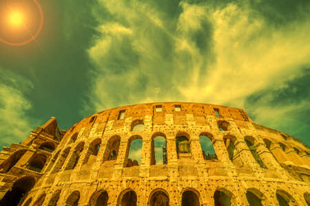 View outside the Colosseum, Rome, Italy, with specific ruins and sky with clouds in background. Sunset light.の写真素材