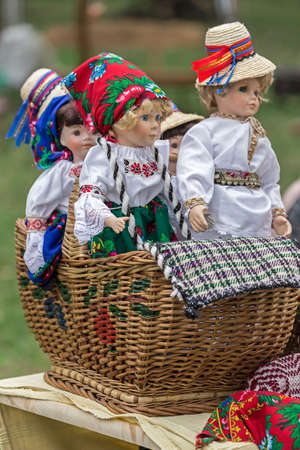 Dolls dressed in traditional Romanian folk costumes and exposed for sale at one traditional fair.の写真素材