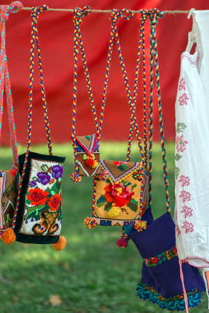 Background with bags embroidered and decorated with specific patterns of the Bistrita-Nasaud area, Romania, exposed for sale.の写真素材