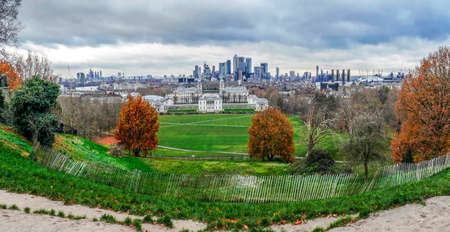 LONDON,ENGLAND - NOVEMBER 27,2017: Panoramic view with Queen's House from Greenwich Hill with the skyline of Canary Wharf on background. Designed by Inigo Jones, the house was completed in around 1636のeditorial素材