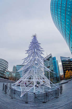 LONDON, ENGLAND - NOVEMBER 27, 2017: Christmas decorative fir tree on the bank of the Thames River near the Town Hall.のeditorial素材