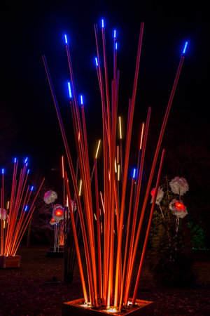 Artificial giant bamboo plants and flowers decorated with lights on Christmas time. Night...