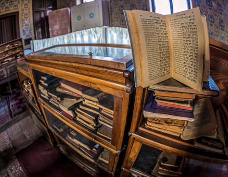ORADEA, ROMANIA - JANUARY 27, 2018: Inside of one small Orthodox Synagogue with lots of books in the Hebrew language.のeditorial素材