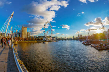 LONDON, ENGLAND - NOVEMBER 28, 2017: View with famous London Eye and Big Ben from Golden Jubilee bridges cross the River Thames. Sunset time.のeditorial素材