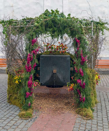 TIMISOARA, ROMANIA - APRIL 28,2017: Fountain with flowers as a memorial monument in honor of the heroes who died in the December 1989 at anti communist revolution. Names of the deceased are inscribed.のeditorial素材