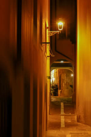 Night view with one small street in Trieste, Italy. Motion blur filter applied.の写真素材