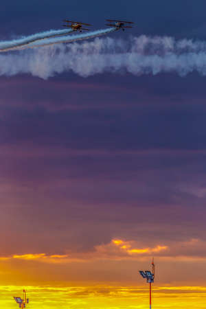TIMISOARA, ROMANIA - JUNE 23, 2018: Vintage airplanes doing demonstrations at one air show organized by international airport from Timisoara. Sunset time.のeditorial素材
