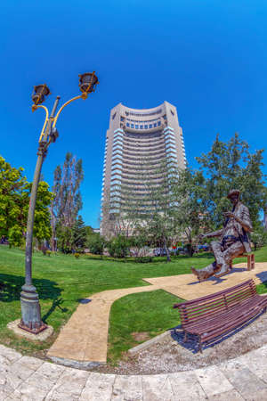 BUCHAREST, ROMANIA - JULY 16, 2018:The statue of romanian writter Ioan Luca Caragiale in front of the Hotel Intercontinental and National Theatre with the same name. Work by the artist Ioan Bolborea.のeditorial素材