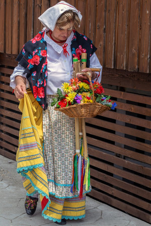 TIMISOARA, ROMANIA - JULY 8, 2018: Mature dancer woman from Italy in traditional costume present at...