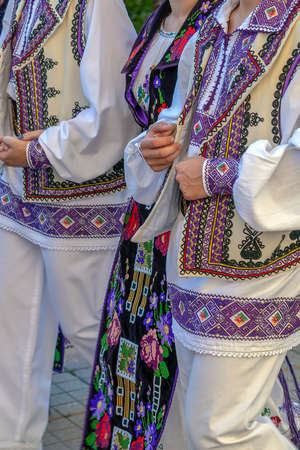 Detail of Romanian folk costume for women and men, with multi colored embroidery, specific for Banat area.の写真素材
