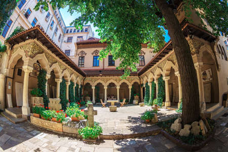 BUCHAREST, ROMANIA - JULY 16, 2018: The inner courtyard of Stavropoleos monastery, founded in 1724 by the Greek monk Ioanikia Stratonikeas, a masterpiece of Brancovan architectural style.のeditorial素材
