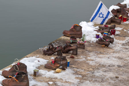 Budapest, Hungary - December 19, 2018: Shoes on the Danube shore are a monument created in memory of...