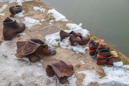 Budapest, Hungary - December 19, 2018: Shoes on the Danube shore are a monument created in memory of the Jews killed during the Second World War by the Arrow Cross Party soldier's between 1944-1945.のeditorial素材