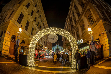 BUDAPEST, HUNGARY - DECEMBER 18, 2018: Christmas Market and Advent Feast in front of the St Stephen's Basilica. People along the market stalls with food, sweets, gifts and crafts.のeditorial素材